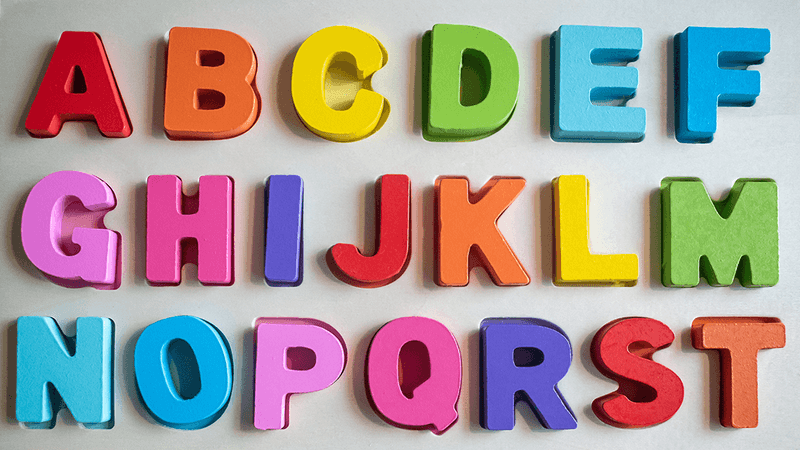 The alphabet spelled in fridge magnets, going from A to T.