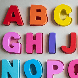 The alphabet spelled in fridge magnets, going from A to T.