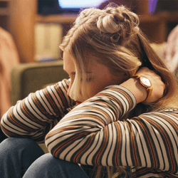 section of DNA (left); young woman hunched over looking stressed (right)