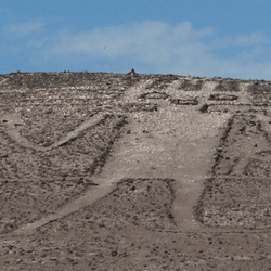 the atacama desert geoglyph etches 119 meters across a hillside, he has a spiky had and what looks like a trident