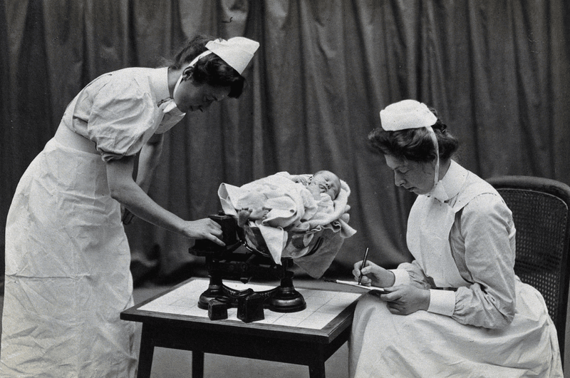 Nurses care for a baby at London's General Lying-In Hospital, one of the first maternity hospitals in the UK, in 1908.