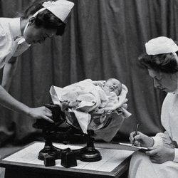 Nurses care for a baby at London's General Lying-In Hospital, one of the first maternity hospitals in the UK, in 1908.