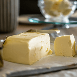 A block of butter on a restaurant table with food