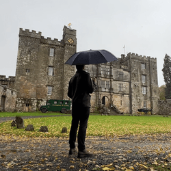 Man standing in front of Chillingham Castle