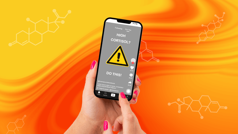close up of a person holding a phone with TikTok open, featuring a video with a warning sign about high cortisol