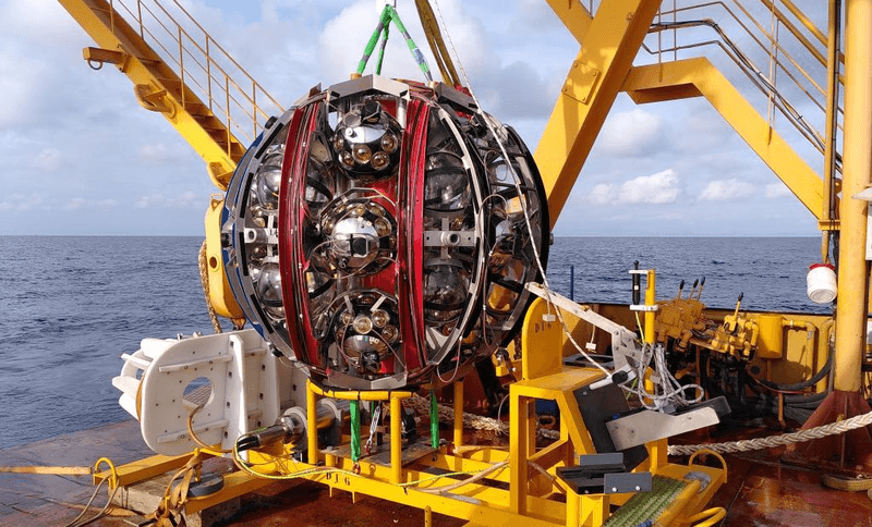 A detector preparing to be lowered into the Mediterranean where it wil capture showers of light created by cosmic rays and neutrinos. Some of these detectors have picked up what is probably the highest energy neutrino ever observed.