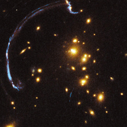 Gravitational lensing of light by galaxies.