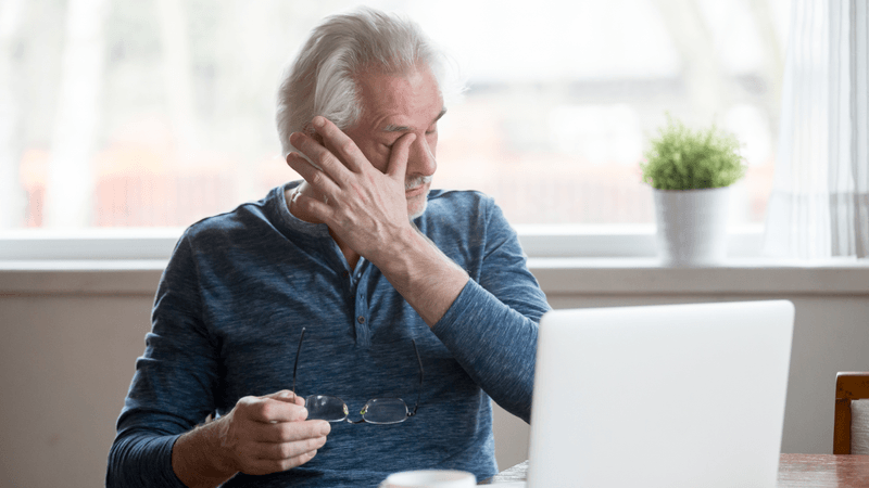 man using griefbot crying at laptop