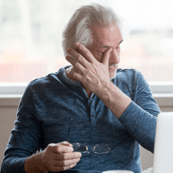 man using griefbot crying at laptop