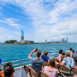  Cruises ferry carrying tourists front of the Statue of Liberty in New York City, USA