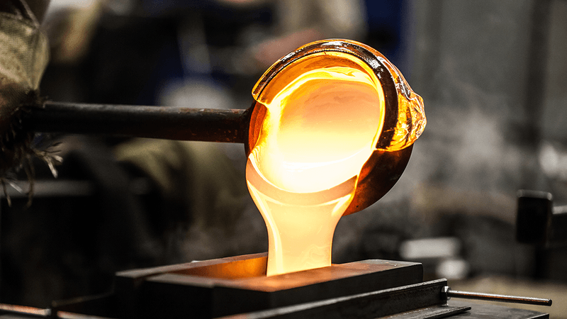 Molten glass being poured into a mold.