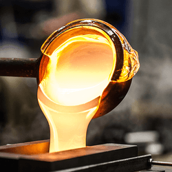 Molten glass being poured into a mold.