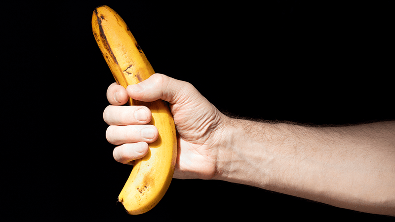 A man holding a banana. 