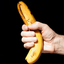 A man holding a banana. 