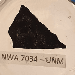 A slice taken from NSWA 7034, also known as Black Beauty, an asteroid that contains crystals from many parts of Mars, including one very revealing zircon