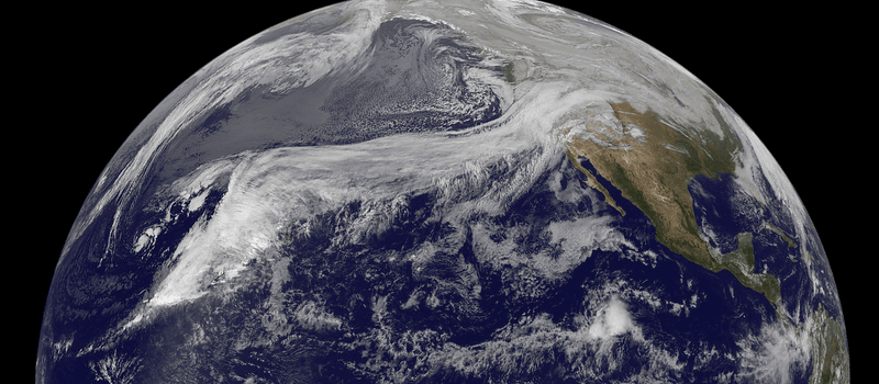 A satellite captures a view over the Pacific with clouds illustrating the movement of the "Pineapple Express" atmospheric river heading towards the US West Coast.  