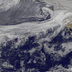 A satellite captures a view over the Pacific with clouds illustrating the movement of the "Pineapple Express" atmospheric river heading towards the US West Coast.  