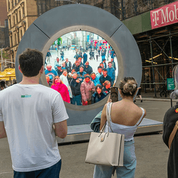 A circular screen in Dublin showing video from New York.