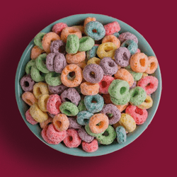 A bowl of colourful cereal clearly dyed using food dyes to appeal to children