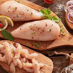 Raw chicken on serving boards.