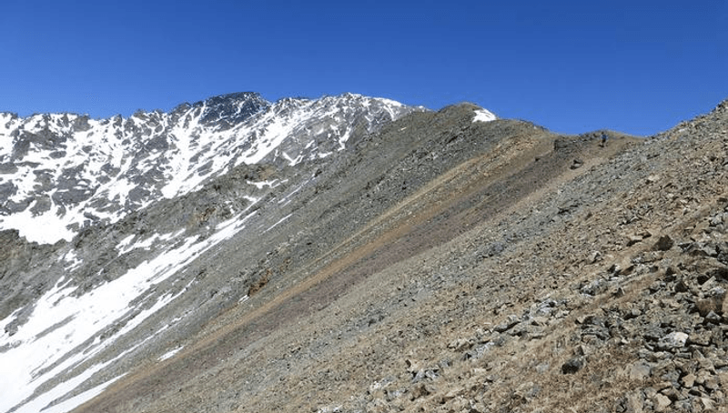 The red band of rock at Arapaho Pass in Colorado dates from a time twice as old as the Rocky Mountains when global glaciers and local geothermal activity drove iron incursions into sandstone.