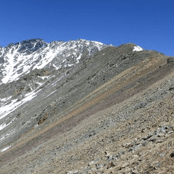 The red band of rock at Arapaho Pass in Colorado dates from a time twice as old as the Rocky Mountains when global glaciers and local geothermal activity drove iron incursions into sandstone.