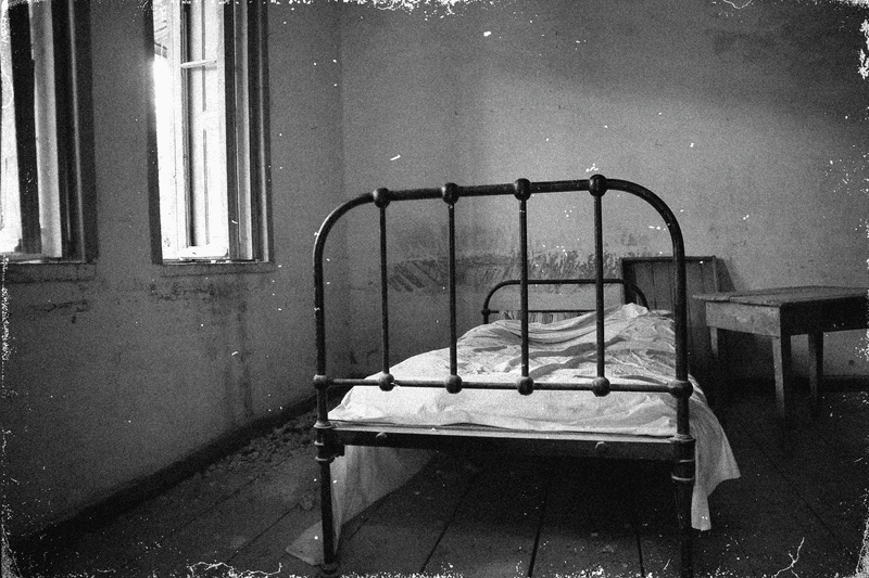 A black and white photo of a bed illustrating the urban legend of the Russian Sleep Experiment