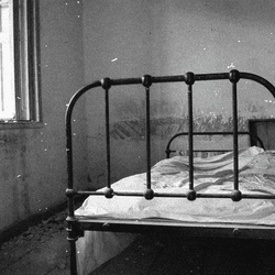 A black and white photo of a bed illustrating the urban legend of the Russian Sleep Experiment