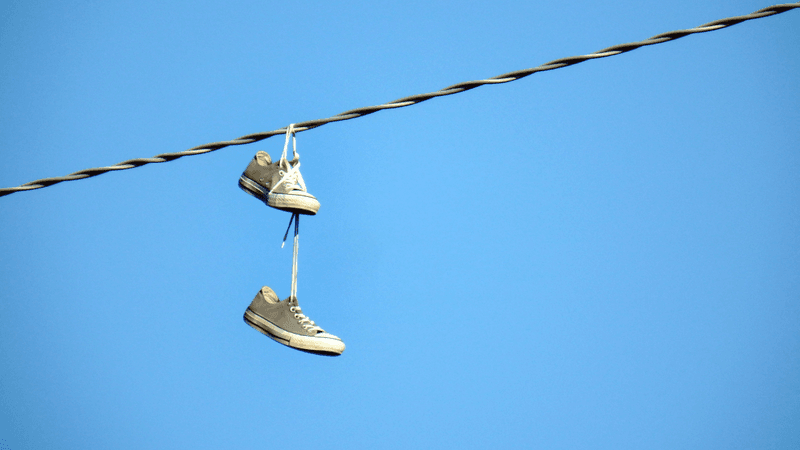 a pair of sneakers wrapped around a powerline