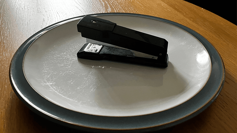 A stapler on a plate.