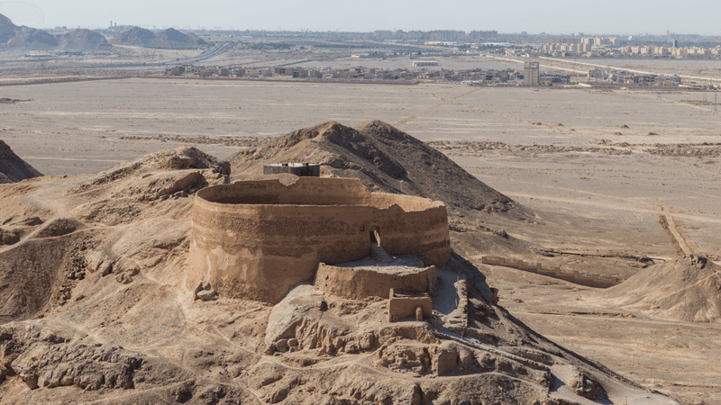 a round tower in a desert where bodies are left to be fed on by vultures