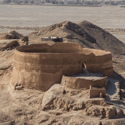 a round tower in a desert where bodies are left to be fed on by vultures