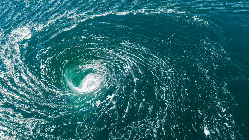 blue ocean water swirling into a whirlpool