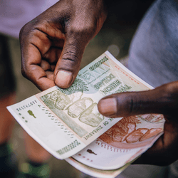 Man counting Zimbabwean dollar’s in Victoria Falls, Zimbabwe